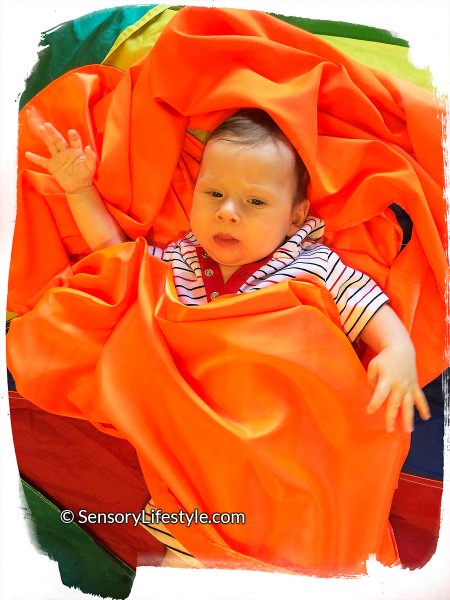 2 month baby activities: playing in fabric