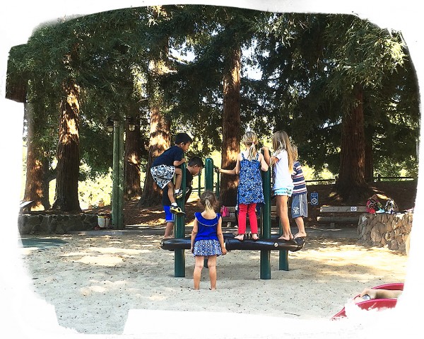 Playground benefits: Children playing on tire